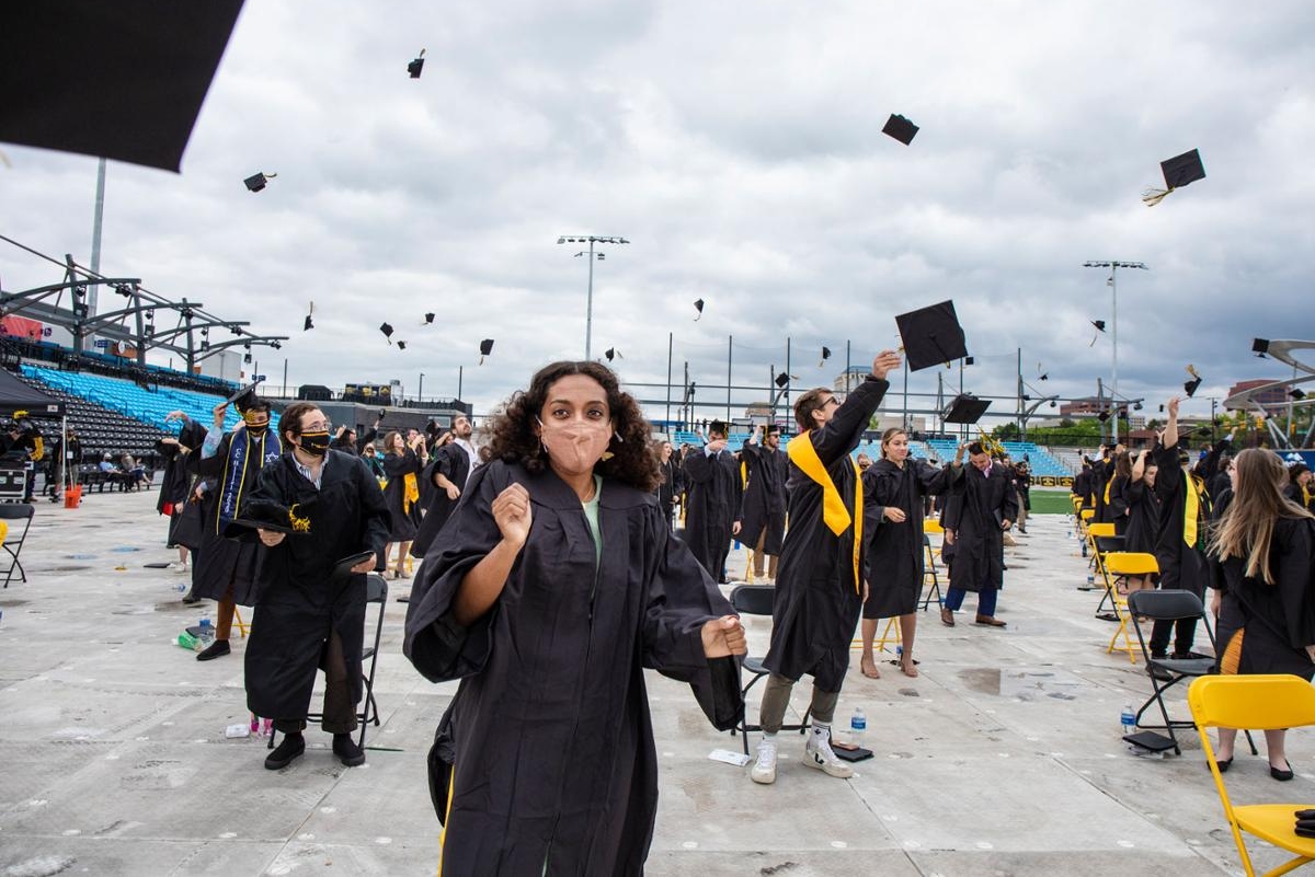 Graduates toss their caps at Commencement