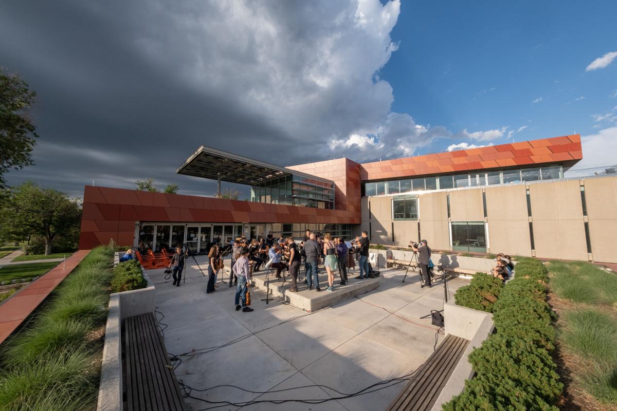 During the 2021 Summer Music Festival, performers convene on the Tutt Library balcony to perform the piece "Quiet City" by Aaron Copland. A PBS film crew records the performance as part of the series "Now Hear This," directed and produced by Harry Lynch and hosted by SMF Conductor Scott Yoo. Photo by Josh Birndorf ’20