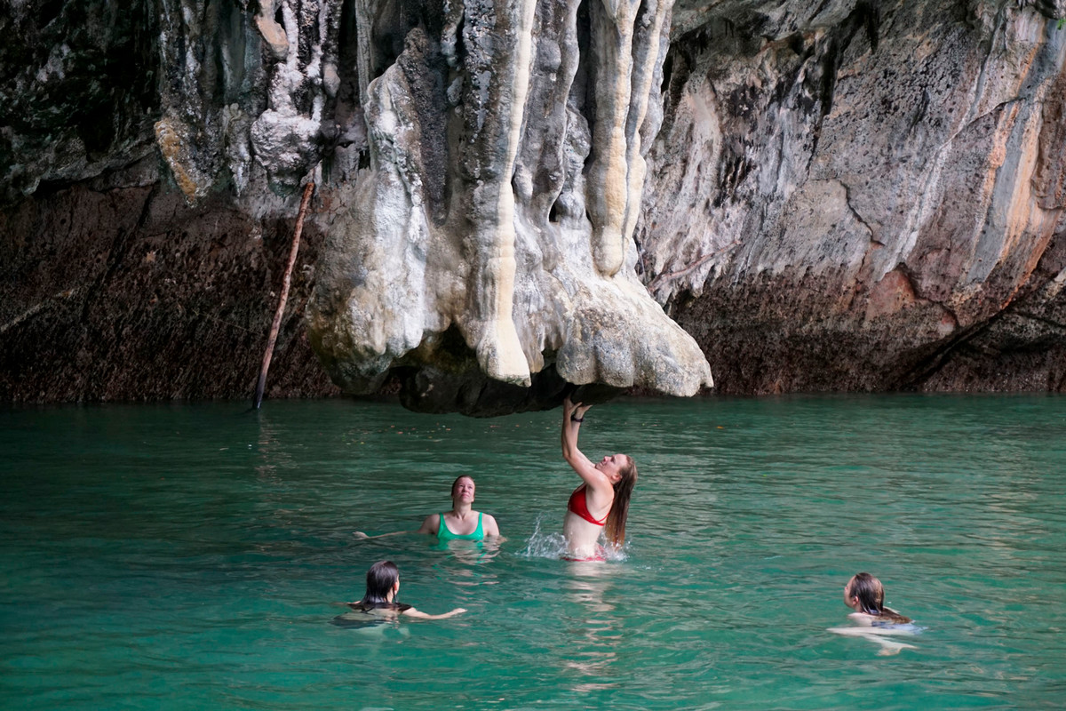 Kate Nelson ’17, RKM Coordinator for Outdoor Education, climbing out of the water with students Eliza Blanning ’26, Olivia Grubb ’25, and Kelli Daugherty ’25 looking on during an Outdoor Ed trip to Thailand during the summer of 2024. Photo provided by Amy Yang ’27.