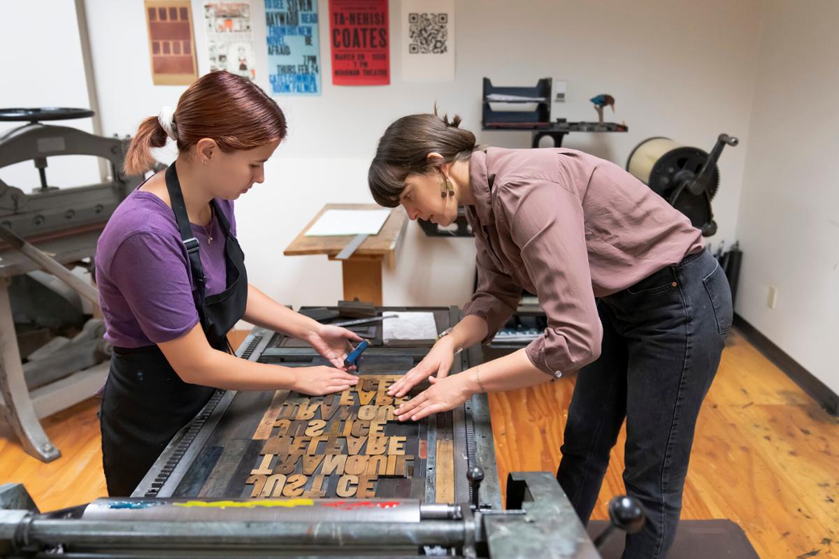 Lydia Campbell’s ’24 letterpress poster project is checked before printing by the Professor Allison Milham in her Book Arts and Letterpress (AS 110) class on Tuesday, 7/12/22 in the Taylor Hall Press.