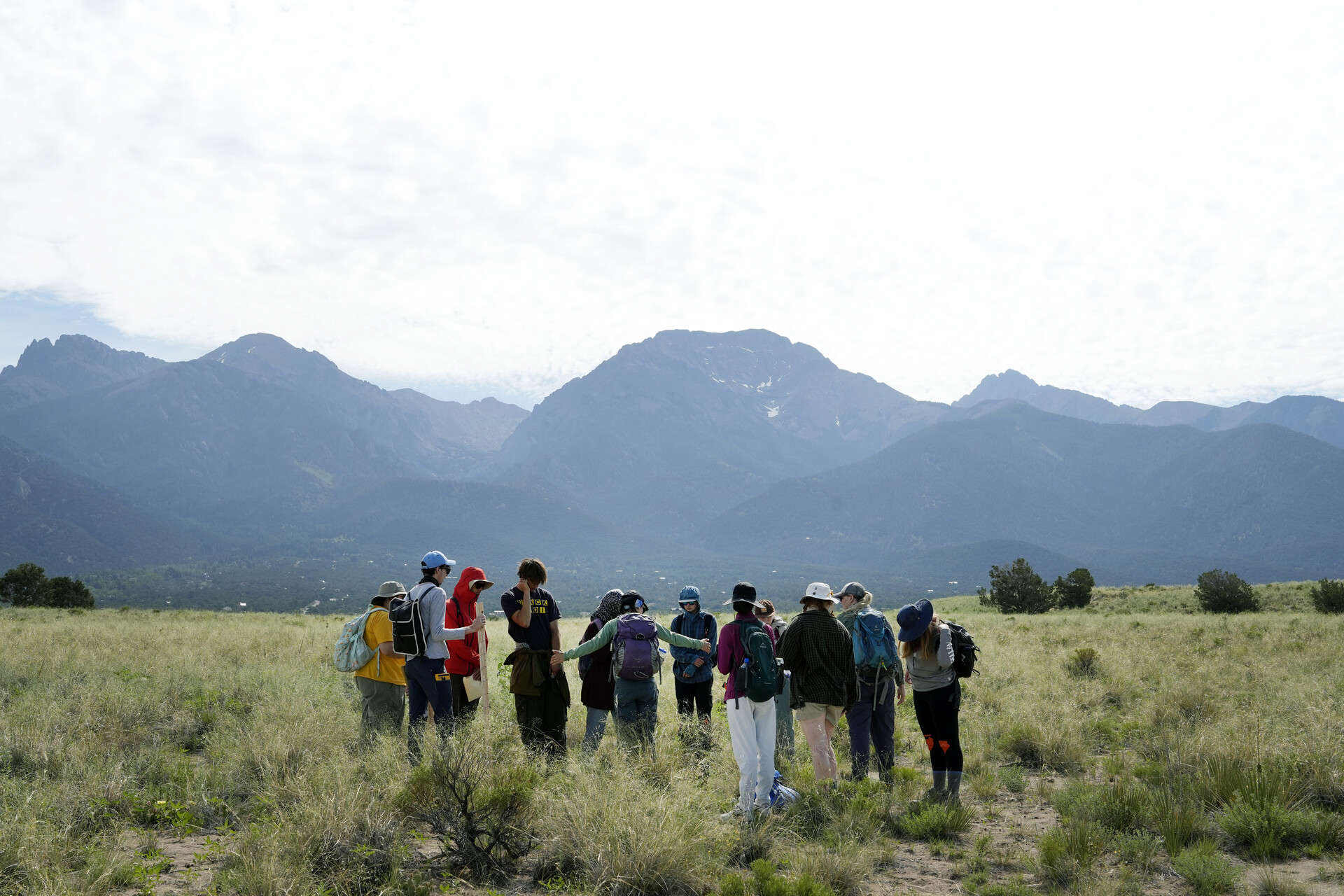 a class meets in the field, and in a literal field, in front of a dramatic backdrop of mountains