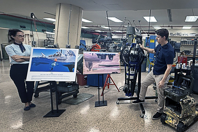 Two members of the National Geographic Exploration Technology Lab demonstrate video technology that descended into the depths of the Mariana Trench. Photo provided by Ryan Bañagale