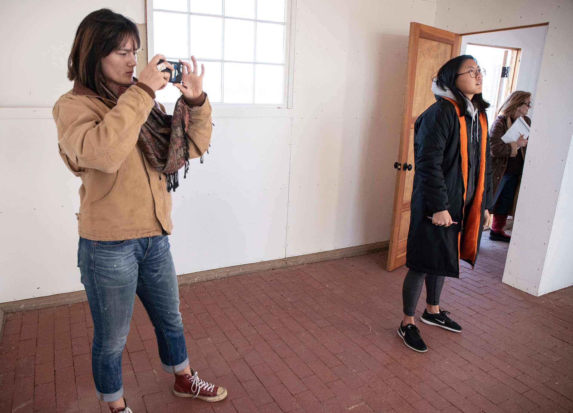 Wayan Buschman ’20 and Jio Chang ’20 take photos and look around the barracks at Amache Internment Camp.  Photo by Jennifer Coombes.