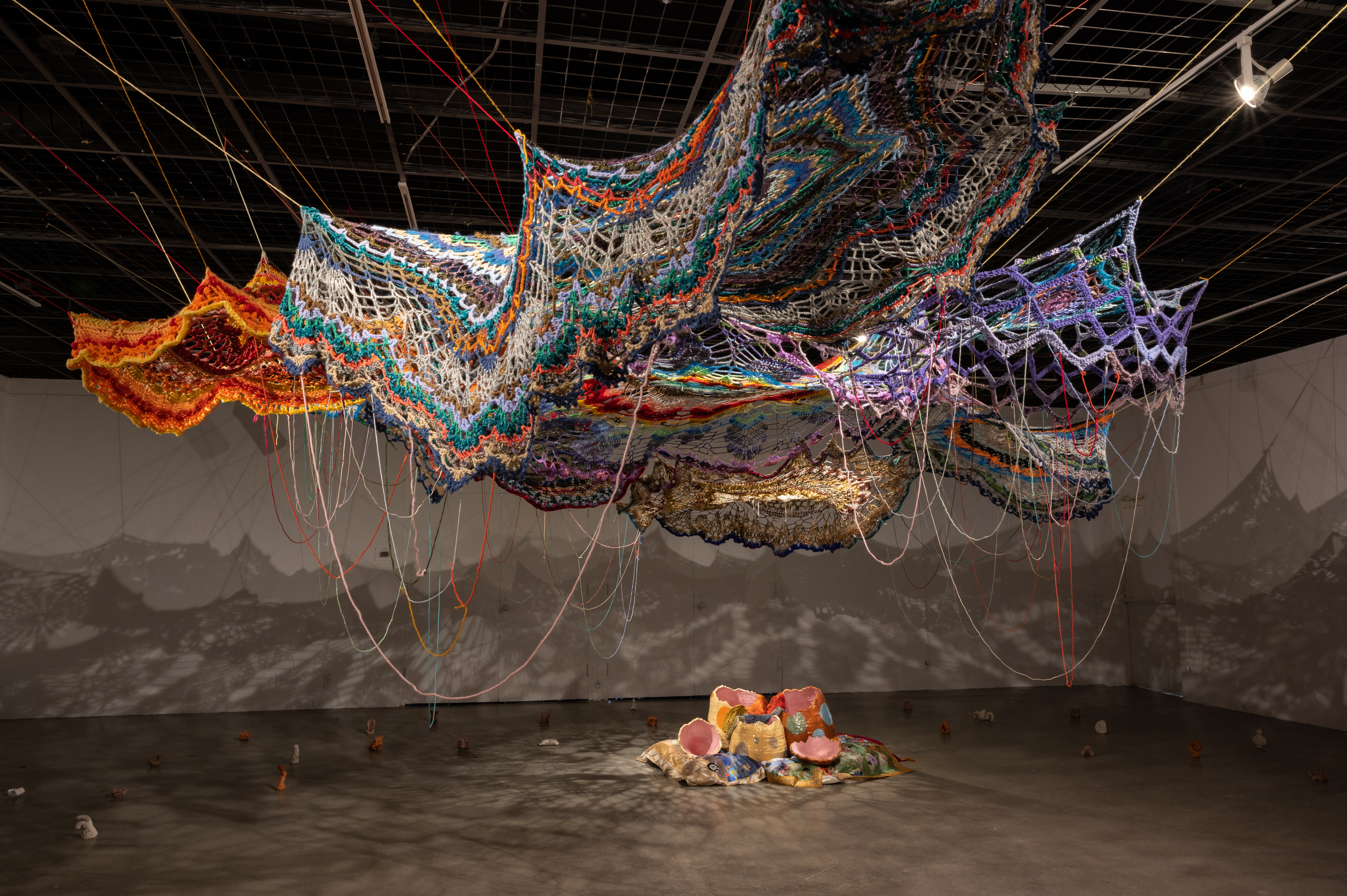 Large scale crocheted installation with ceramic sculpture