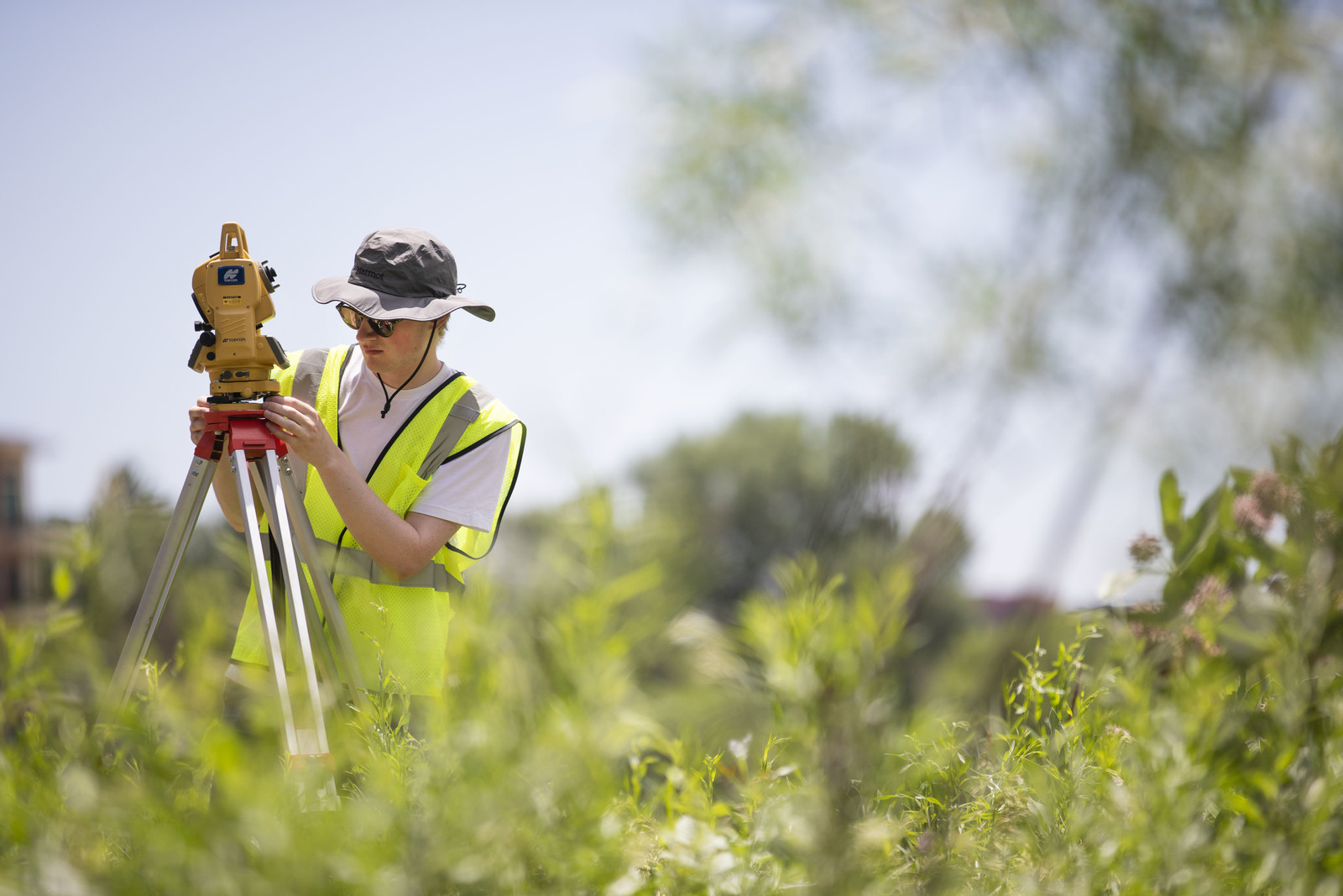 David Sachs works with surveying equipment along with a partner to complete measurements of Monument Creek as a part of student research that will measure and map the changes of the waterway over time.