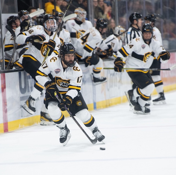 a hockey player puckhandles in Robson arena