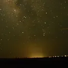 Brightening of the night sky over inhabited areas