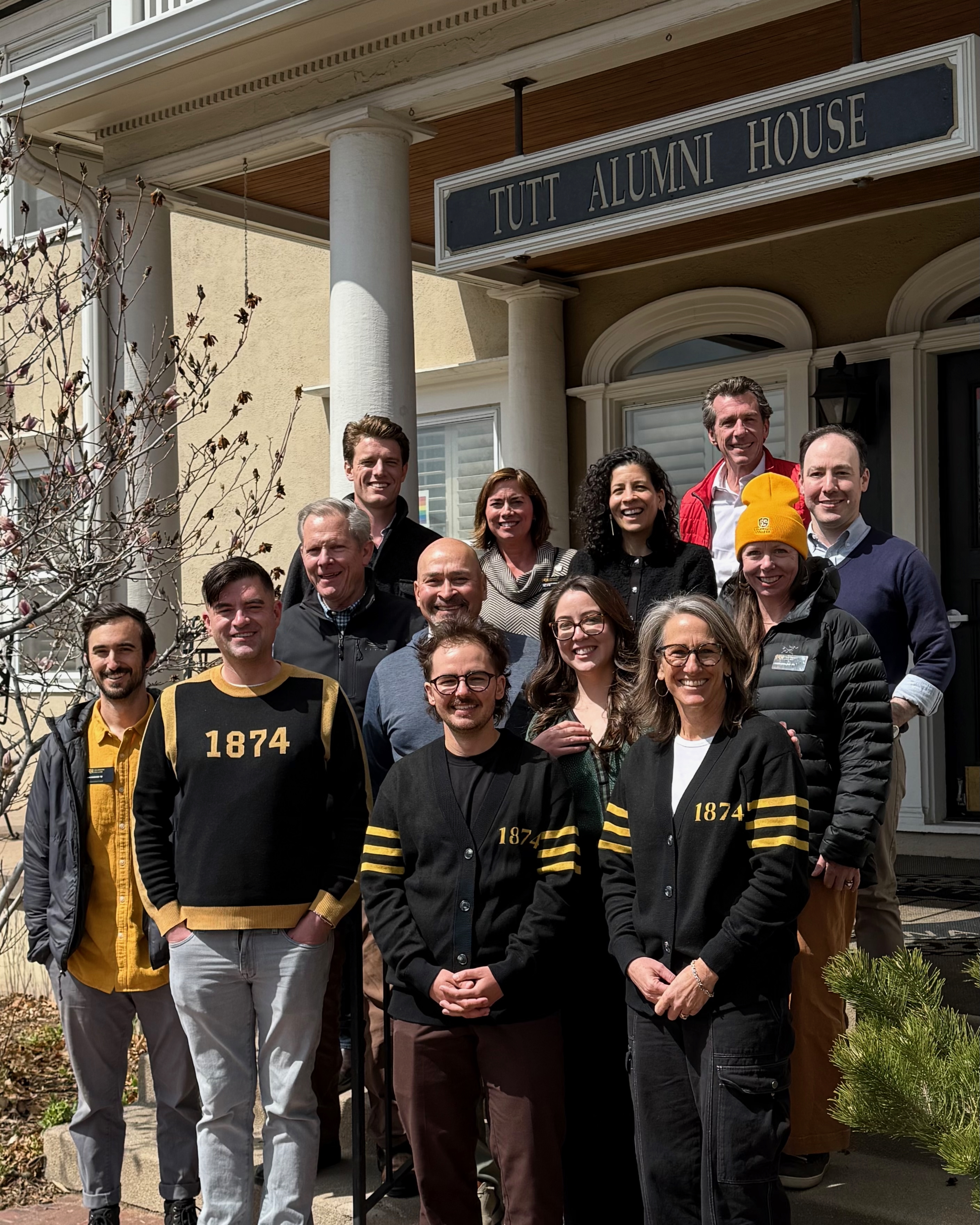 Group photo of aac members standing on the steps of Tutt Alumni House 